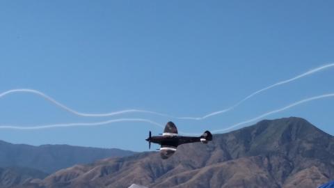 Supermarine Spitfire flying through con-trail